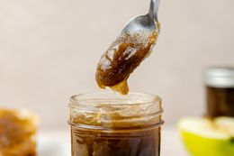 Jar of Apple Butter with Some on a Spoon