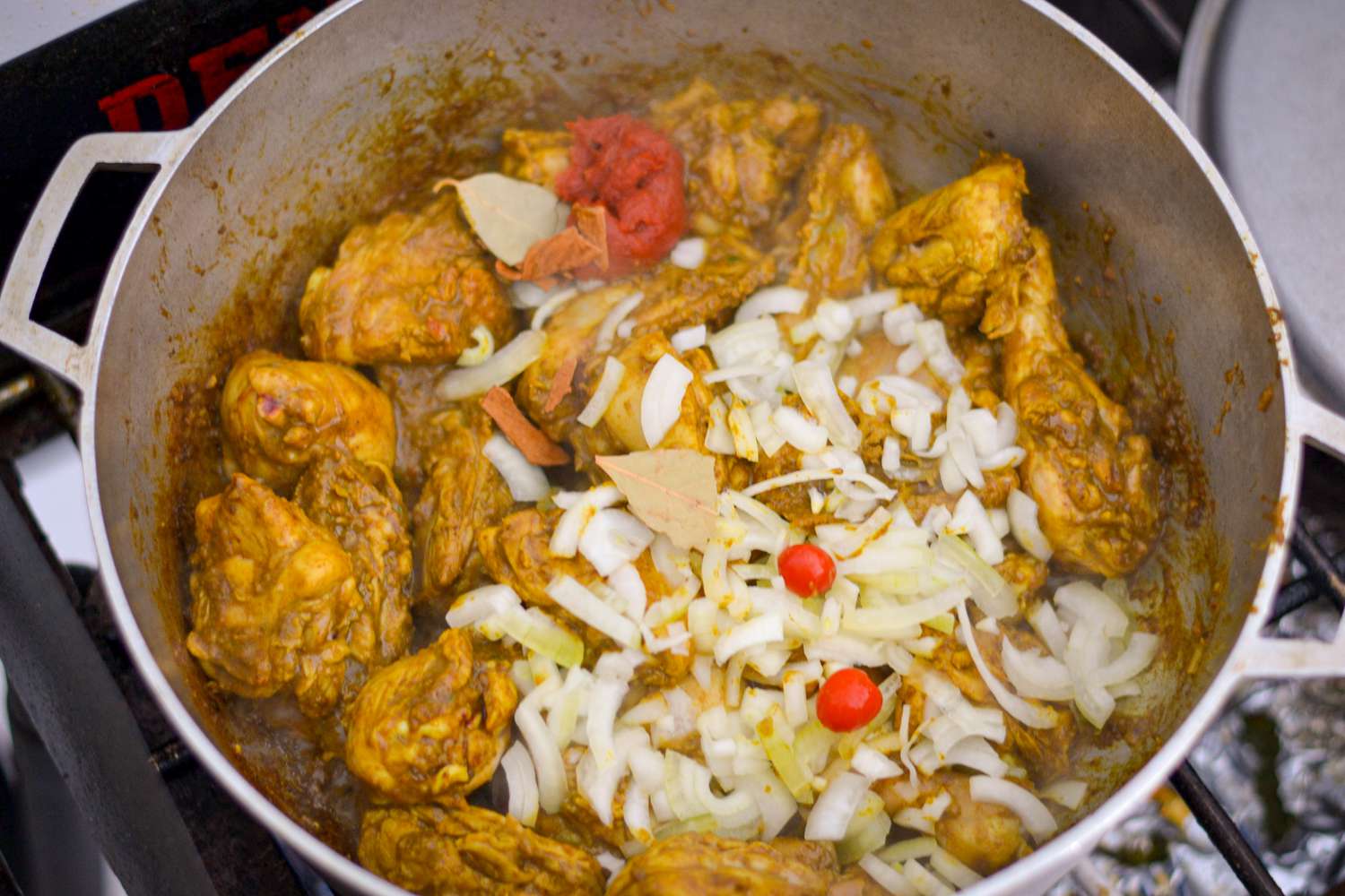 Onions, Peppers, Bay Leaves, and Cinnamon Sticks Added Guyanese Chicken in Pot