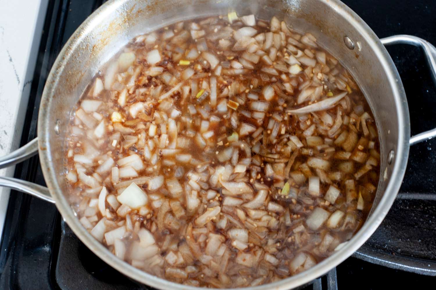 Add balsamic vinegar and chicken stock. 