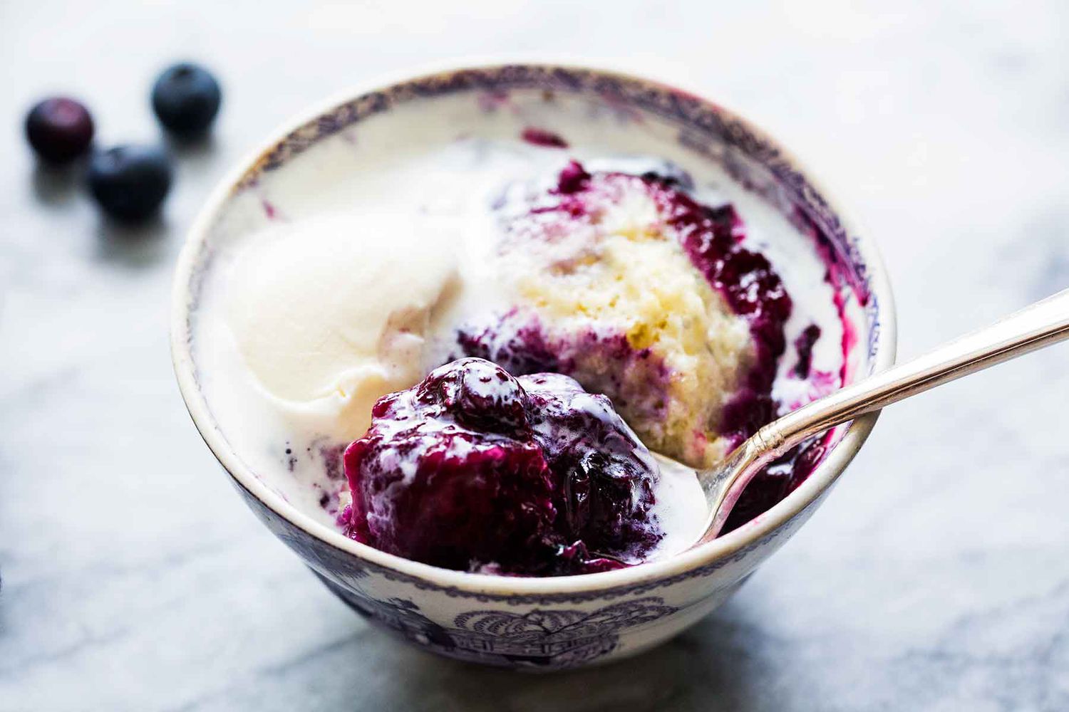 blueberry slump in a bowl with a spoon
