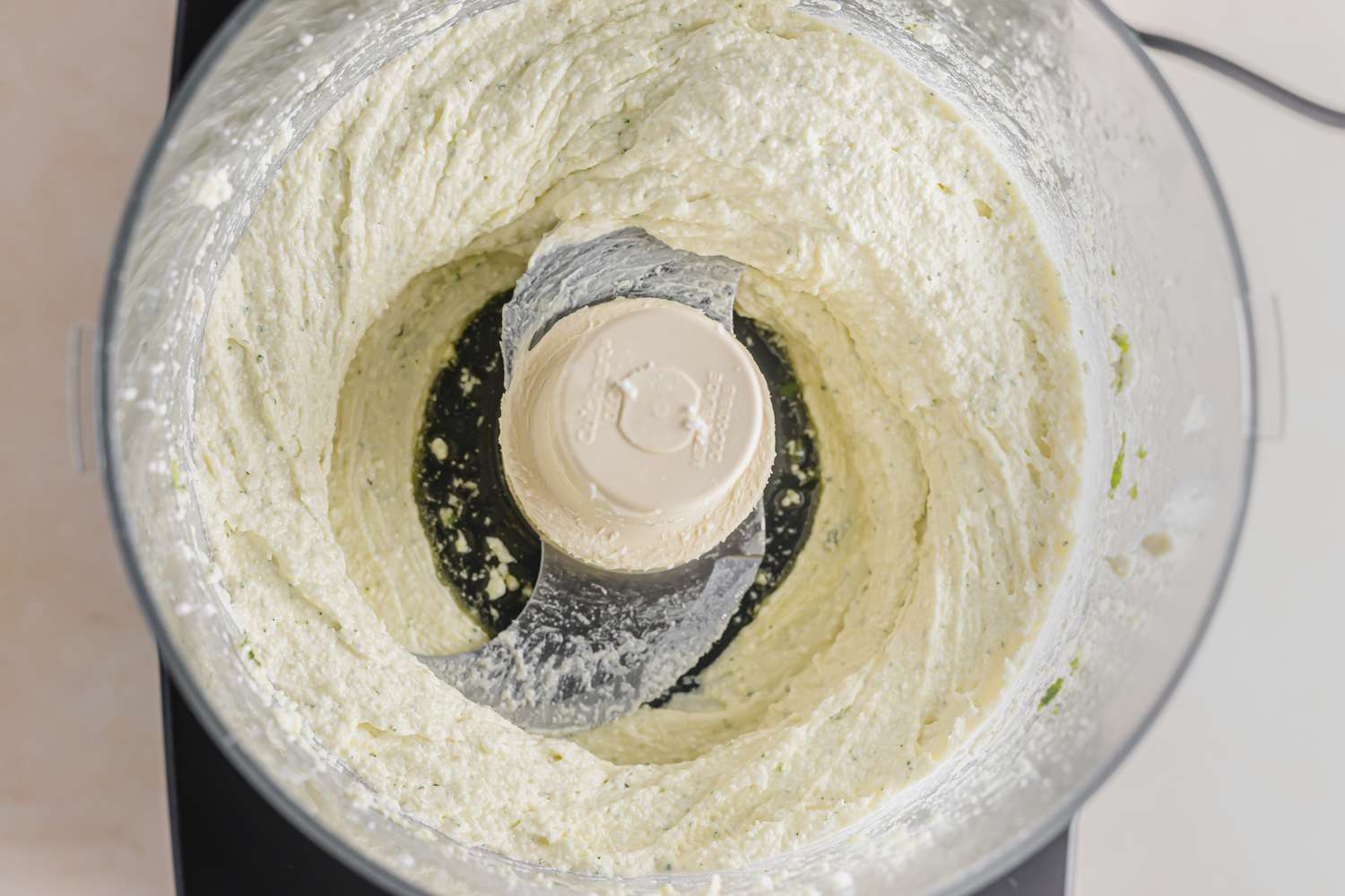 Whipped feta dip in a food processor bowl.