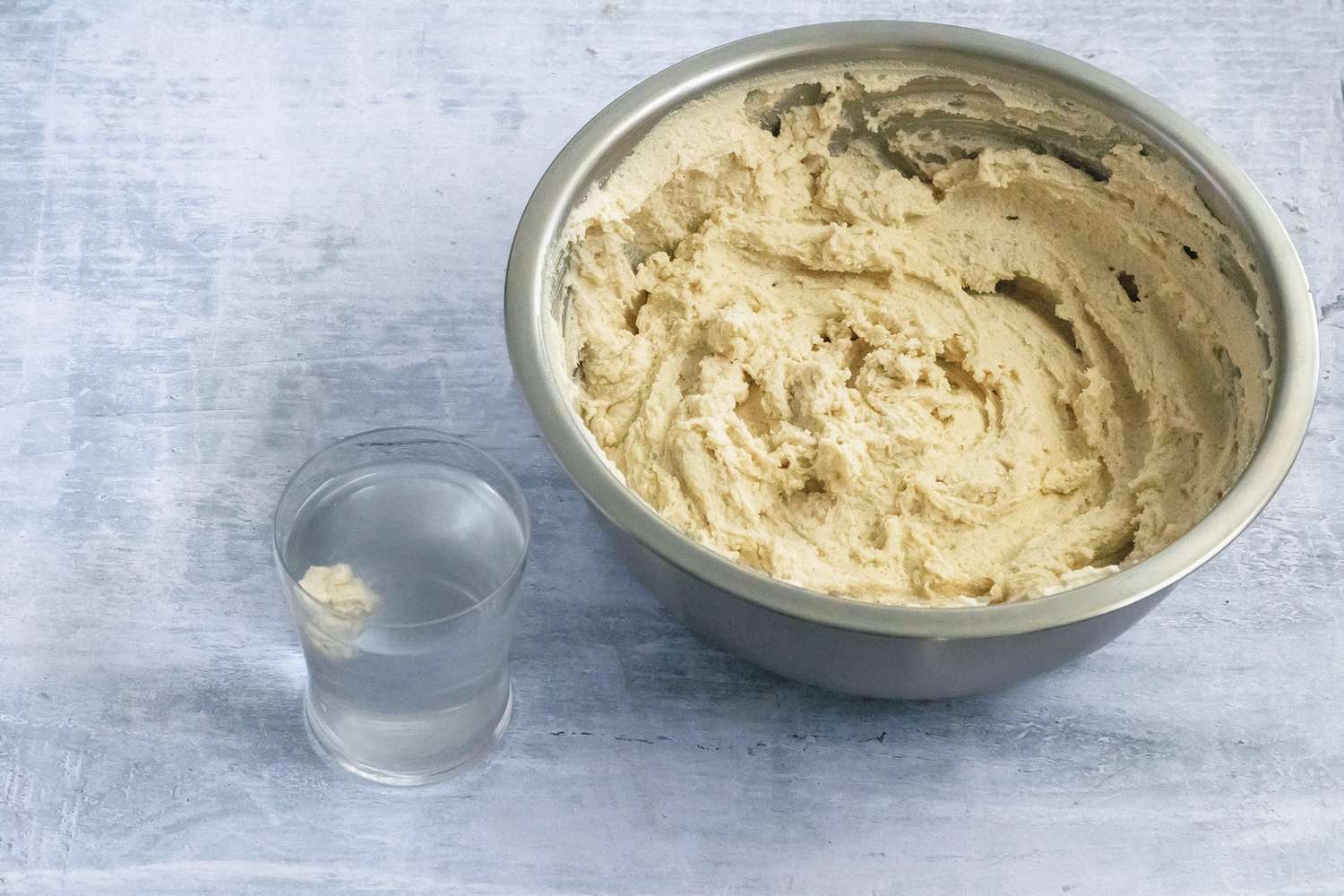 Masa Dough Ball Tested in Water Next to a Bowl of More Masa