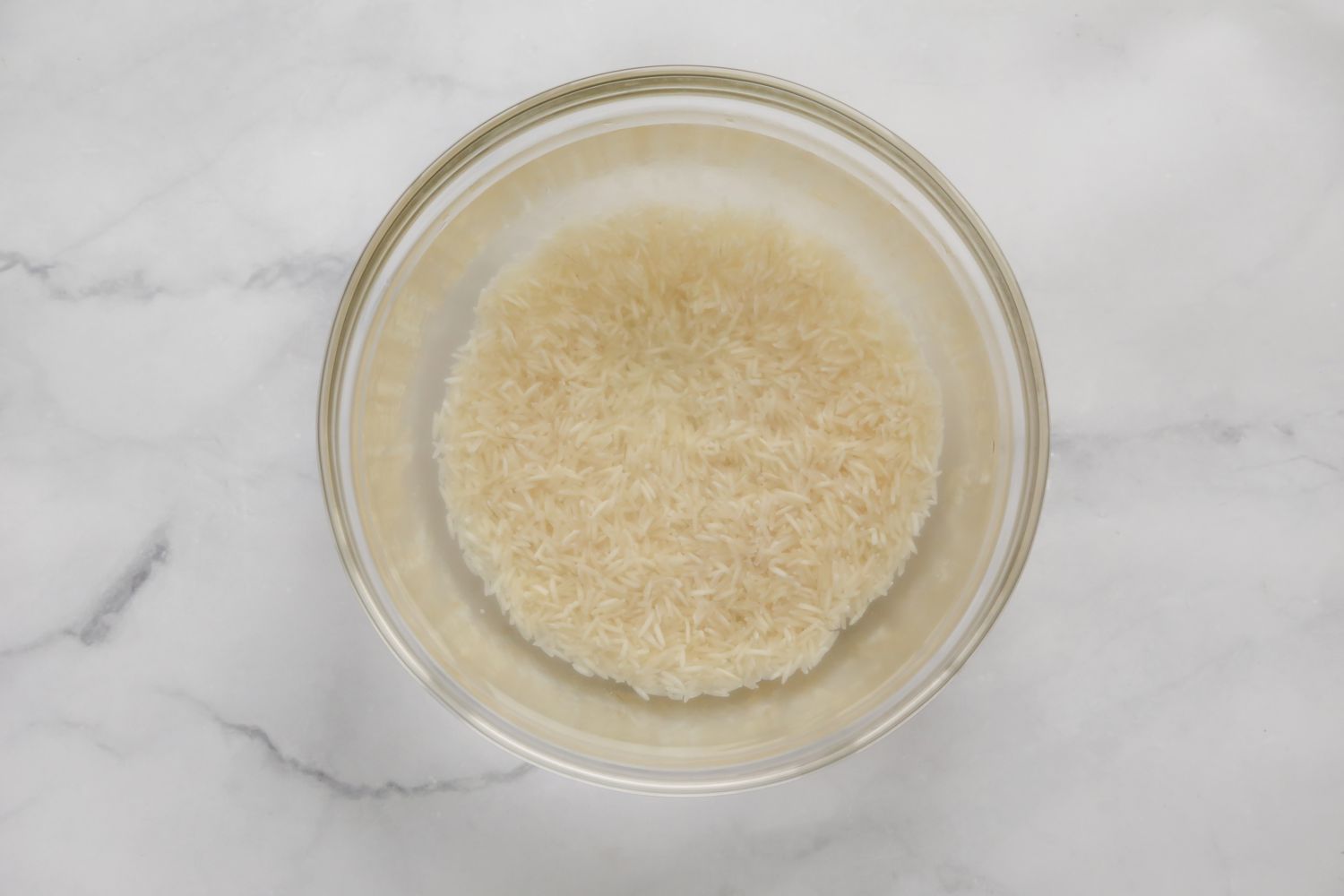 Basmati Rice Soaking in a Bowl of Water for Persian Herb Rice Recipe