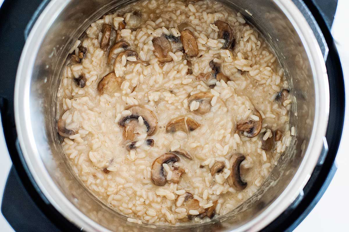 Easy Mushroom Risotto - photograph of risotto and mushrooms inside the bowl of an instant pot