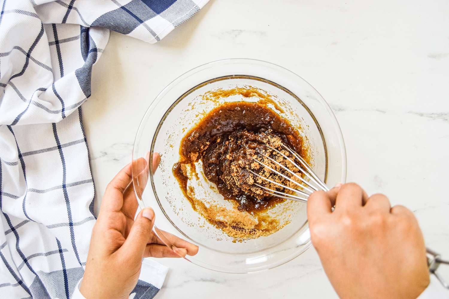 Whisking ingredients in a bowl to make a blondie recipe.