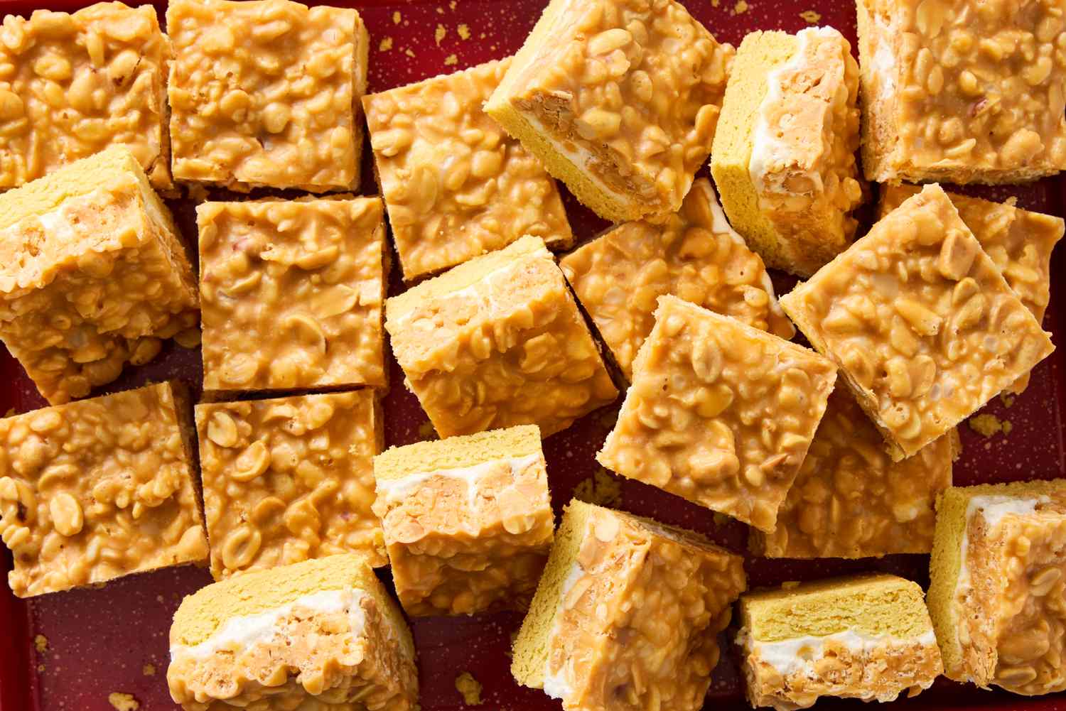 Salted nut roll bars cut into squares arranged on a surface