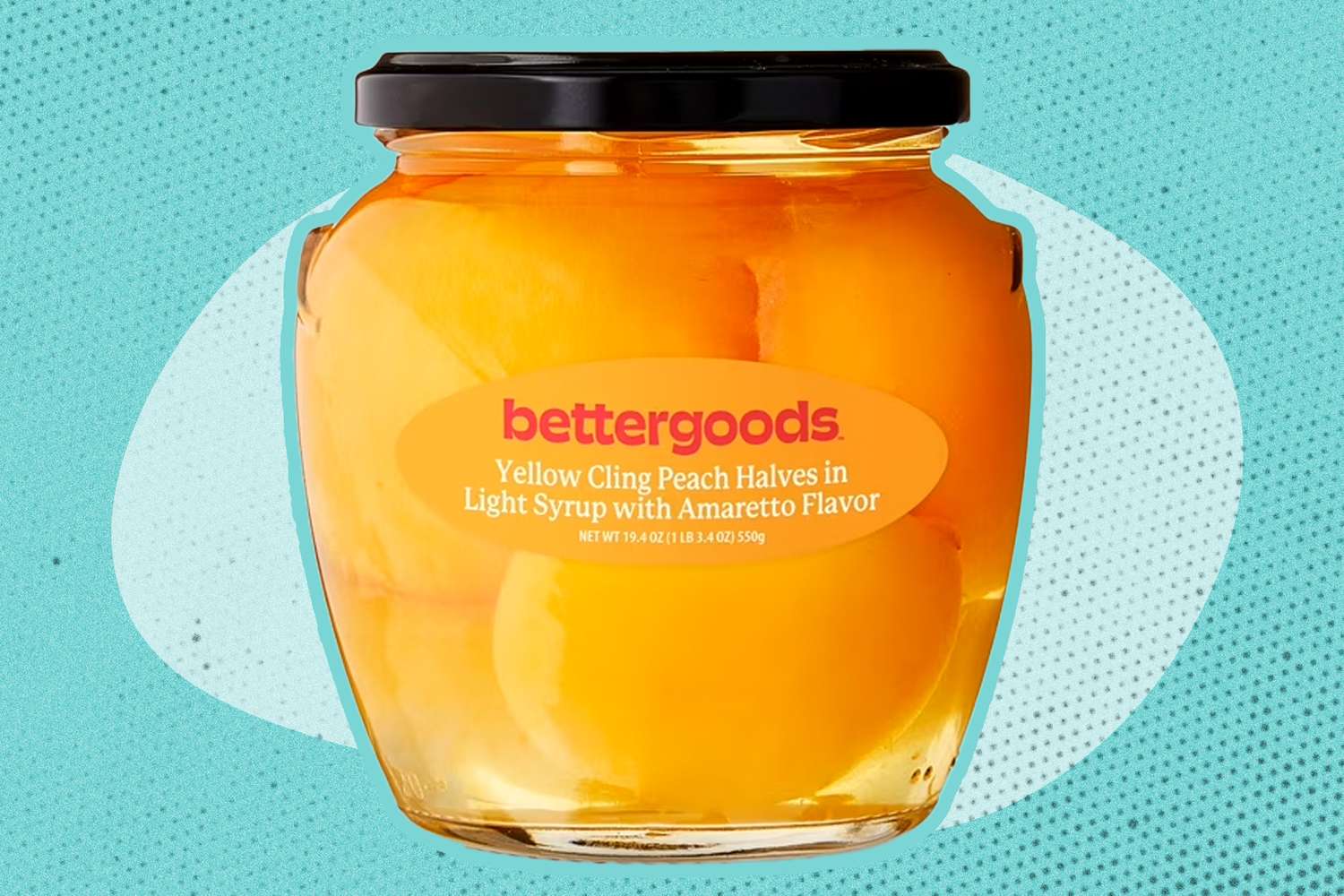 A sealed jar labeled bettergoods with yellow cling peach halves in light amaretto syrup