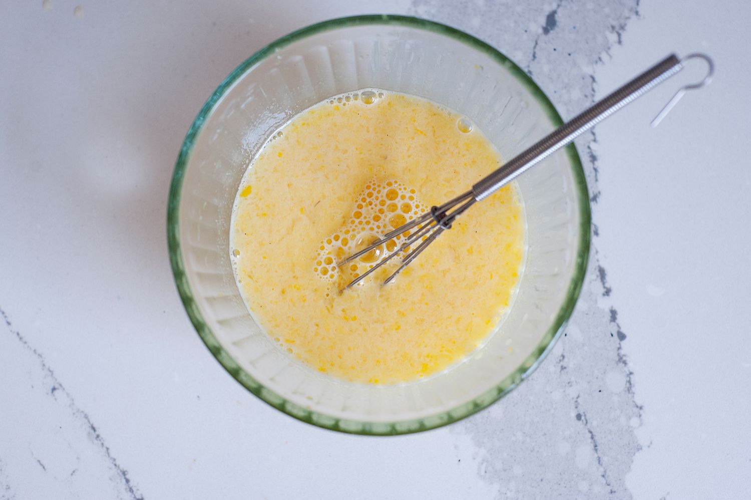 Whisked eggs in a small bowl to make “Ripe Figs” lemon chicken soup.