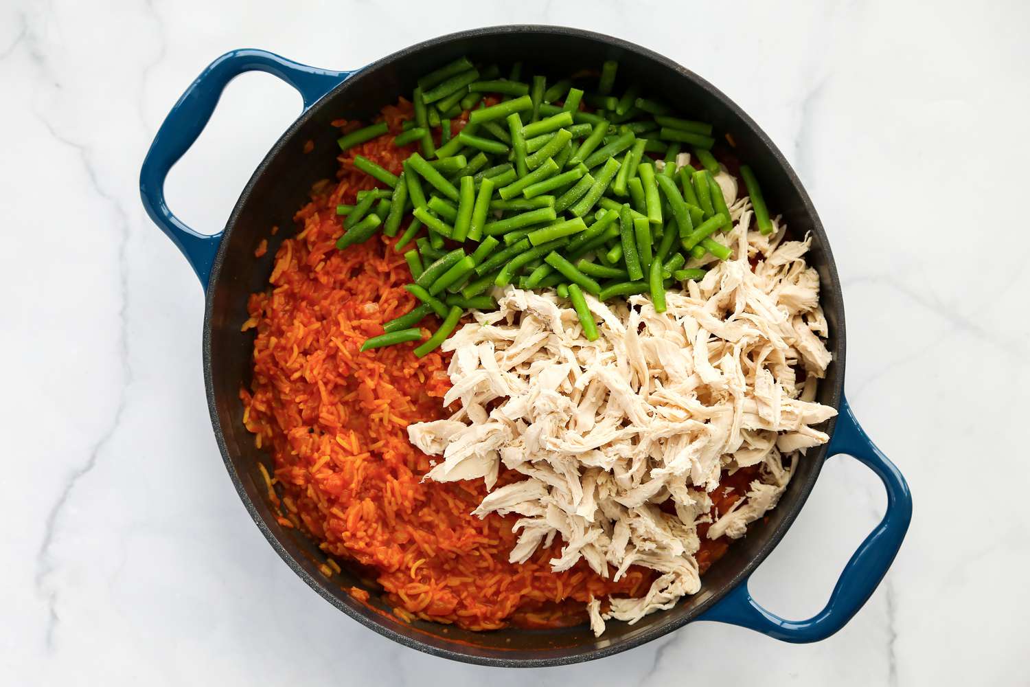Green beans and shredded chicken added to rice