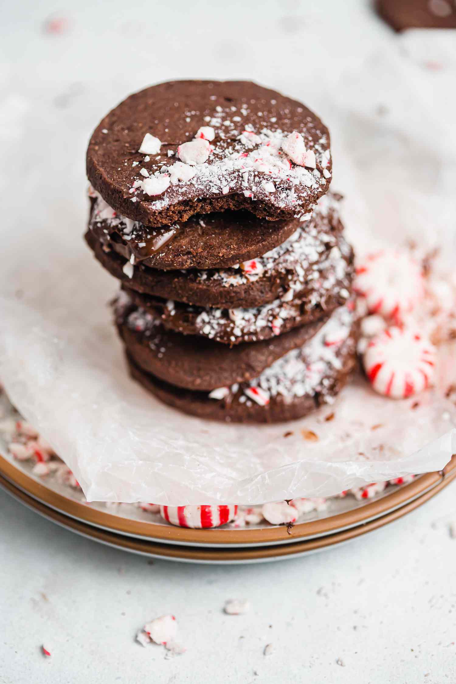Side view of a stack of shortbread dipped in chocolate and peppermint cookies.