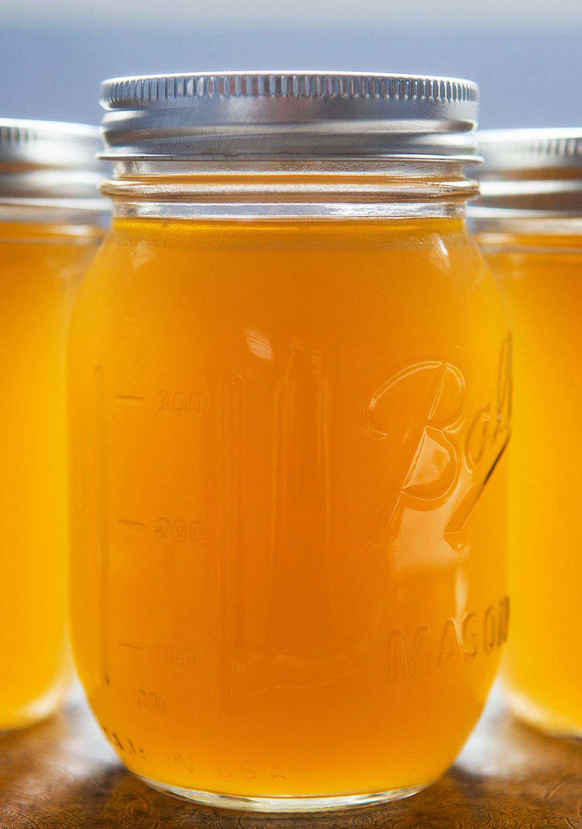 Three canning jars with chicken stock