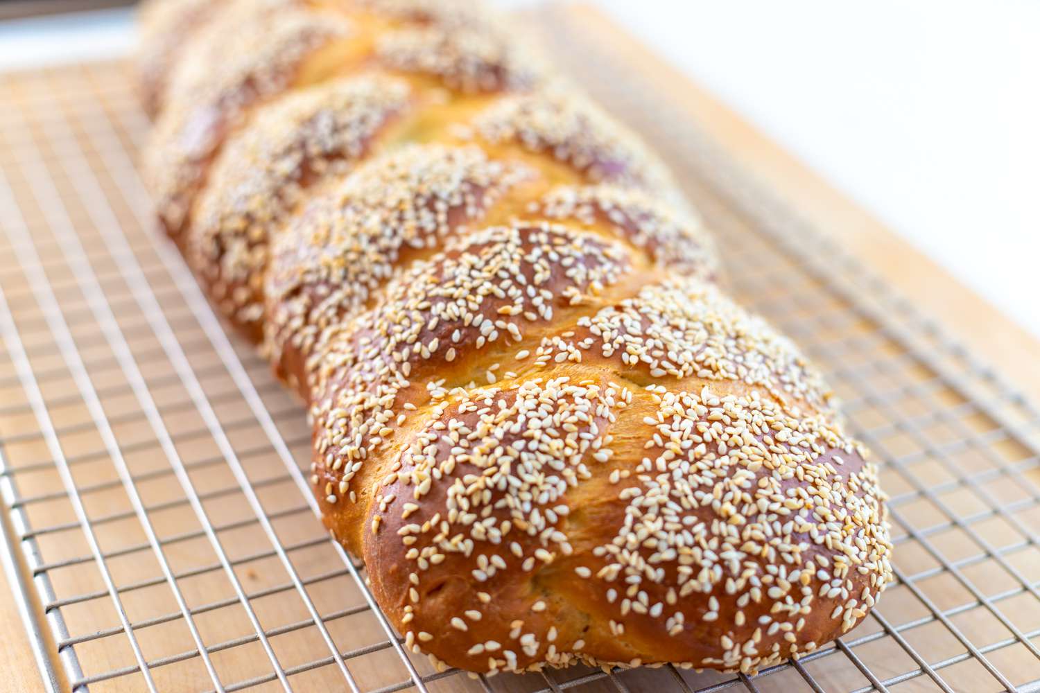 challah with sesame seeds on wire rack
