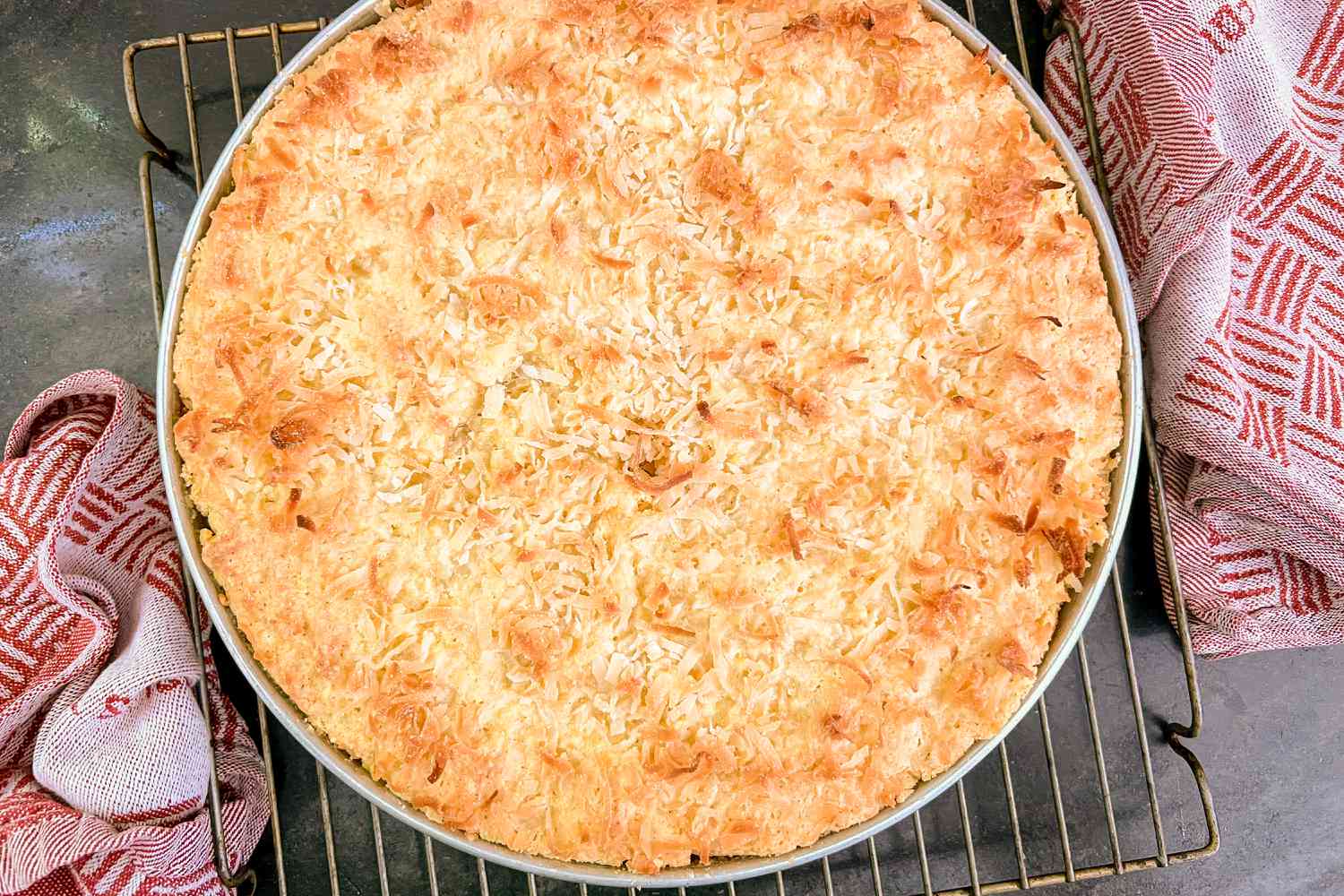 Coconut Macaroon Cake in a pan on a cooling rack