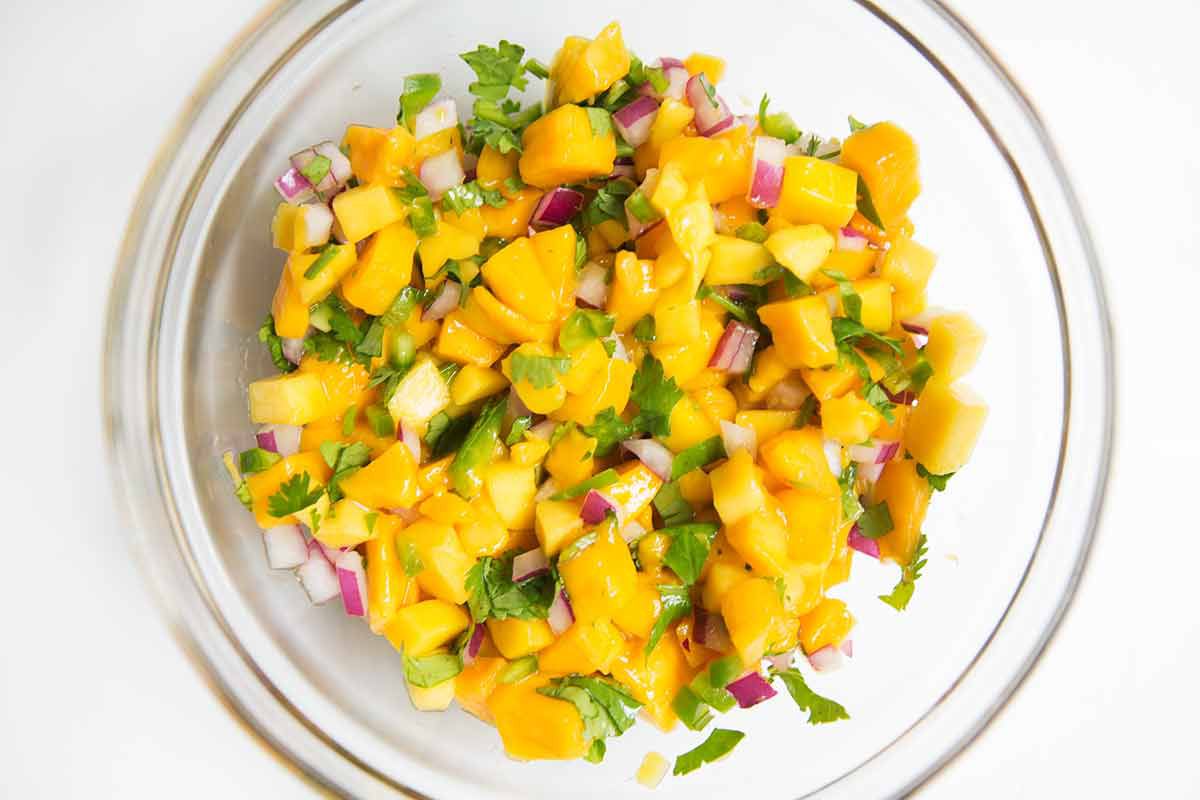 Mango salsa mixed in a glass bowl