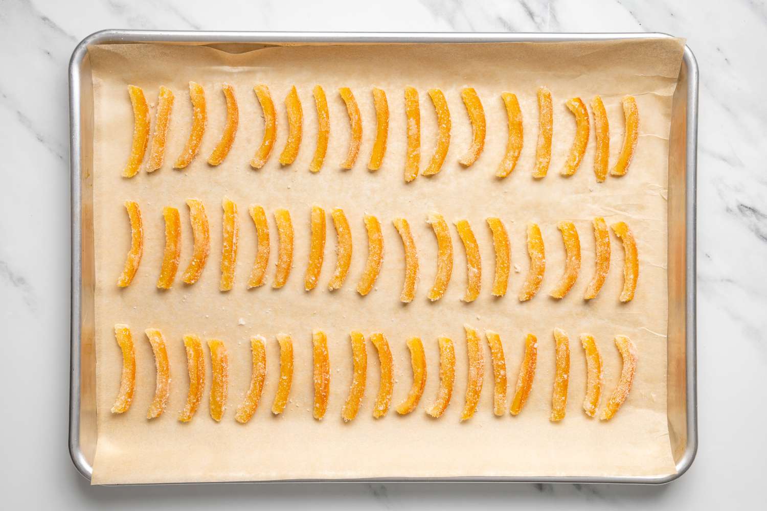 Sugar Coated Orange Slices Resting on a Lined Baking Pan for Chocolate Covered Orange Peels