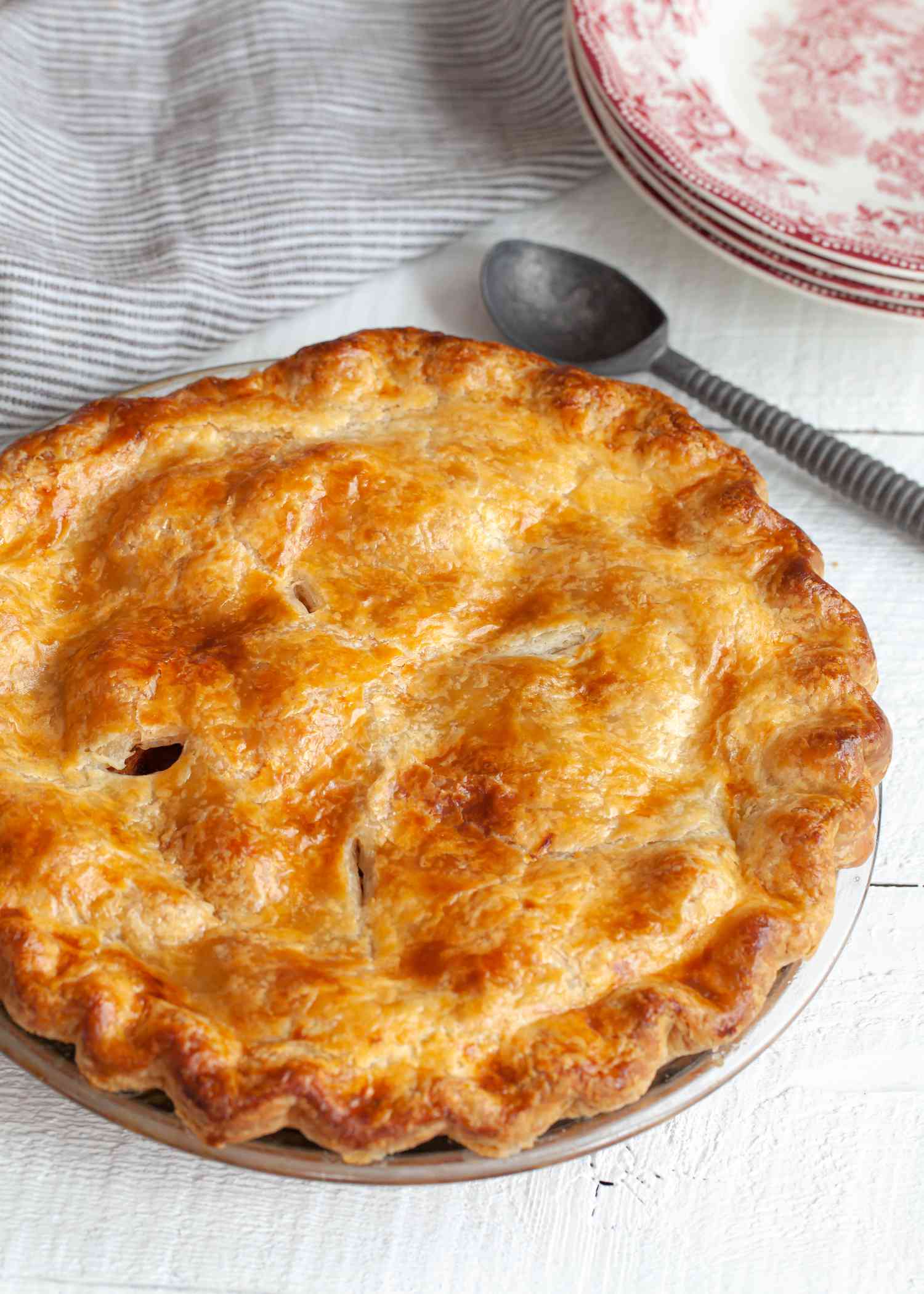 Homemade pie crust used for a pie set on a white background.