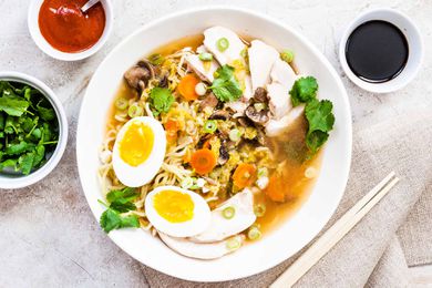 Easy Chicken Ramen Recipe with Noodles and poached eggs in a round bowl