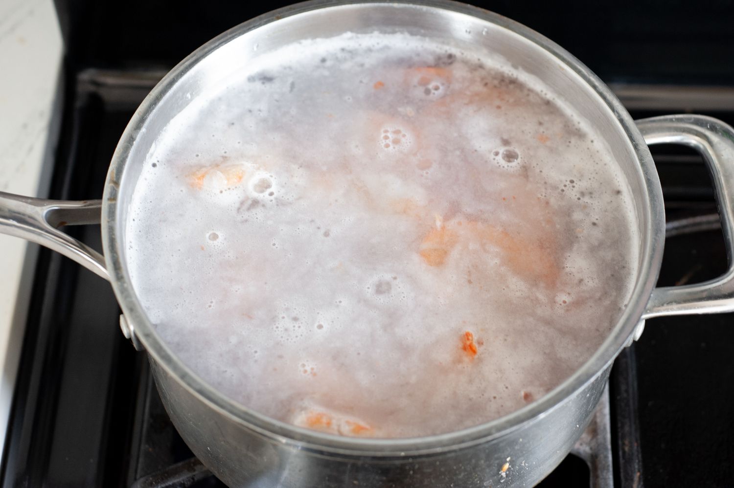 Pot of Shrimp Boiling in Water on a Stove for Shrimp Butter 