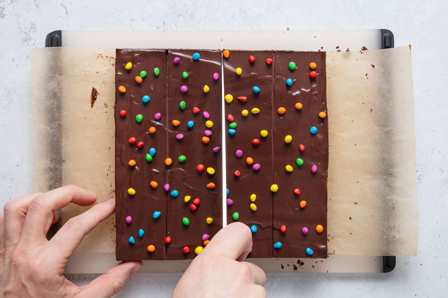 Homemade Cosmic Brownies sliced into bars on a cutting board
