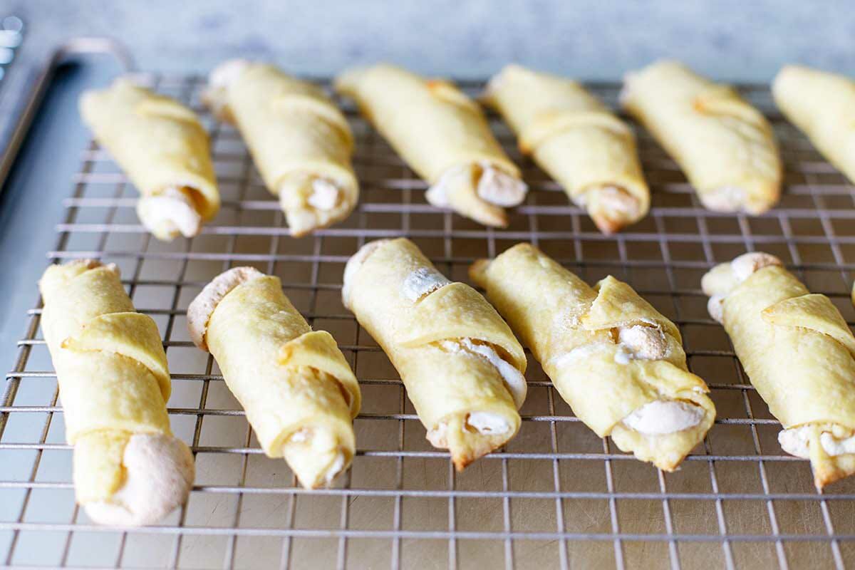 Baked Butterhorn Cookies Filled with Walnut Meringue set on a cooling rack.