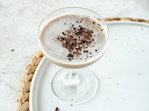 Creamy coffee cocktail on a a white platter.