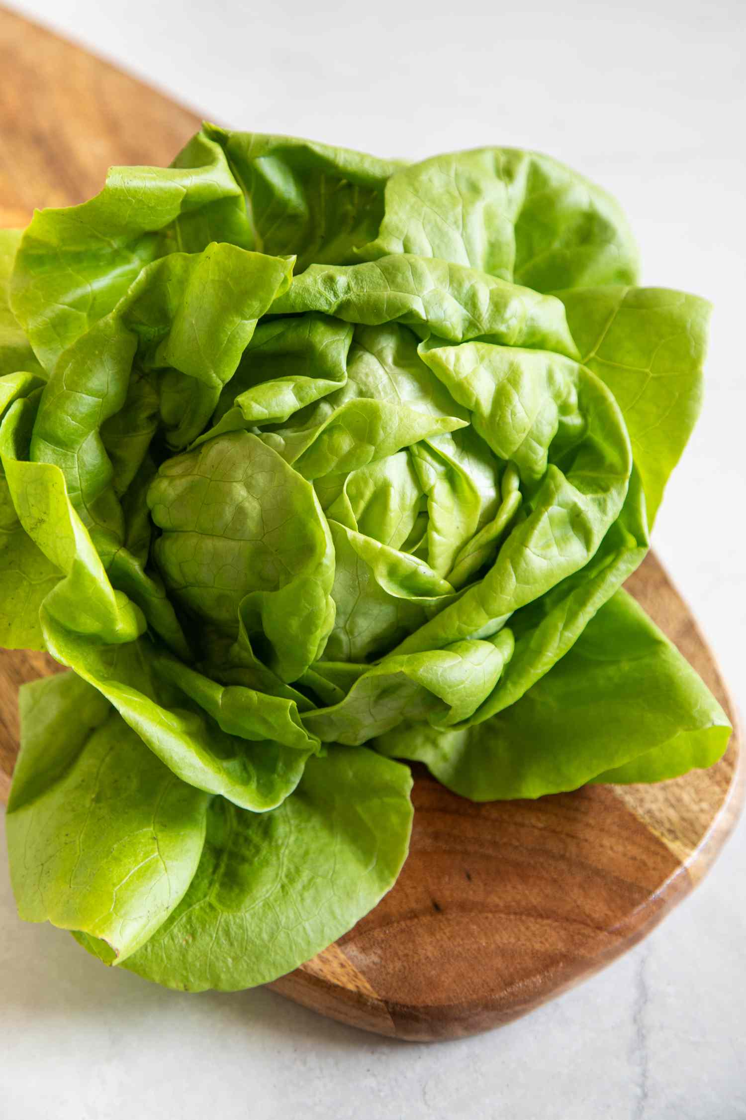 Head of lettuce on a wood cutting board