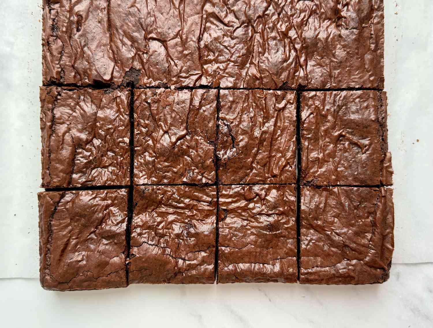 Overhead shot of brownies with a shiny, crackly top