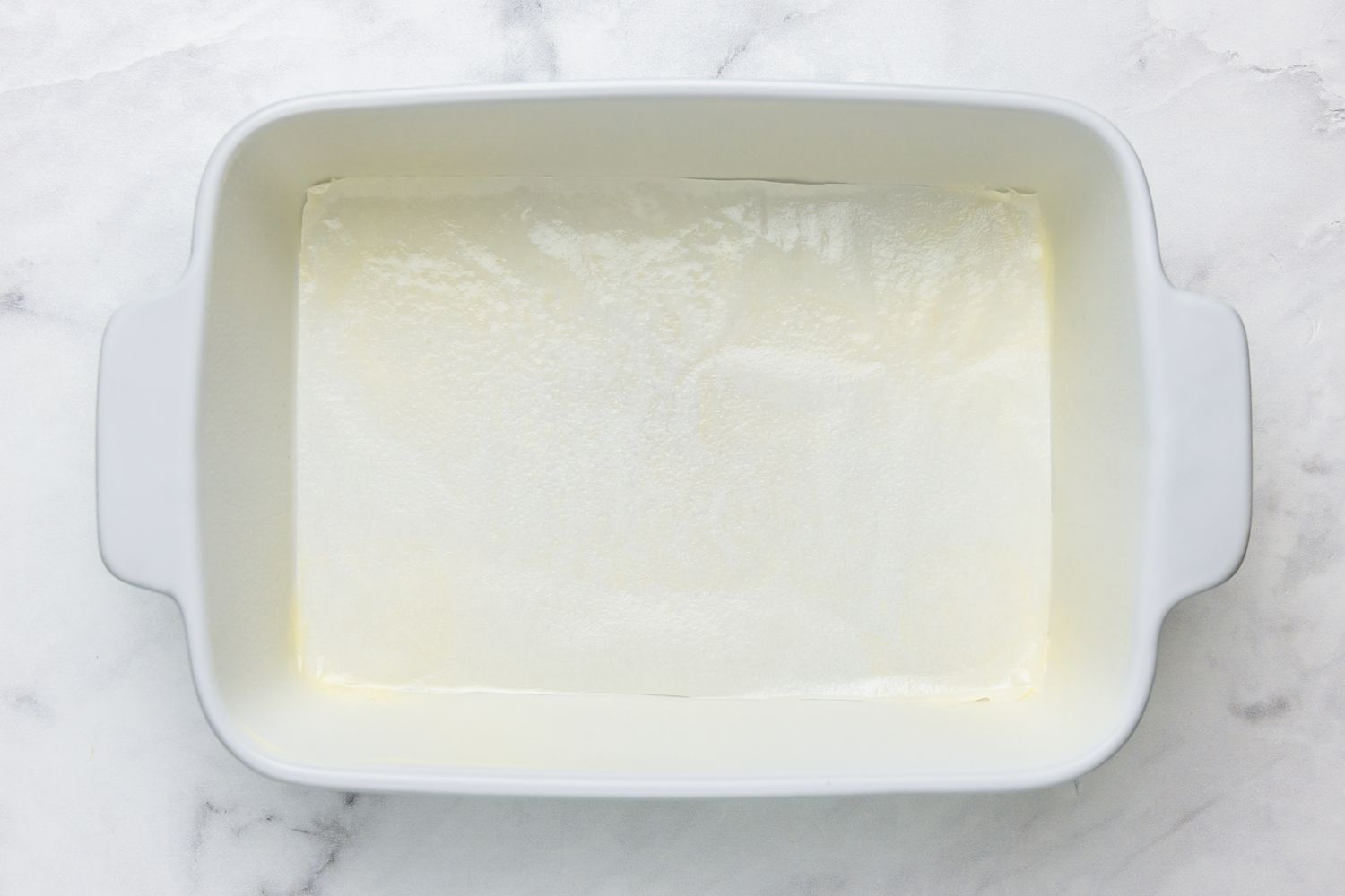 Baking Dish with Bottom Covered with Parchment for Lemon Bar Recipe