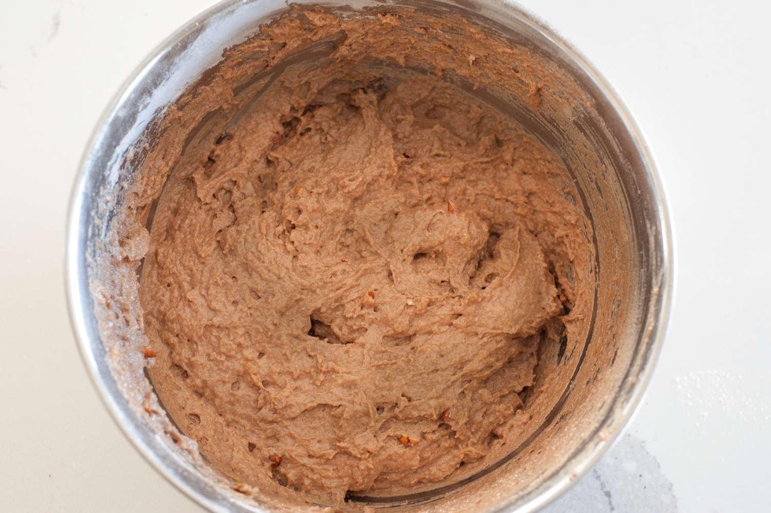 Whole banana bread batter in a bowl.